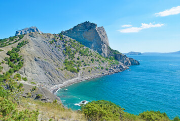 View of a high cliff and a turquoise sea in summer