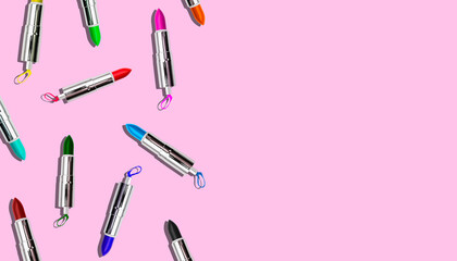 Set of colored lipstick on a pink background. Cosmetic product. Minimal style. Top view with a copy of the space.