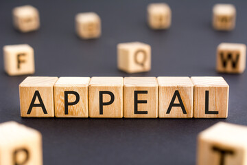 Appeal - word from wooden blocks with letters,  urgent request  appeal concept, random letters around white background