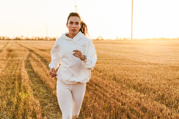 Image of adult beautiful sportswoman running while working out