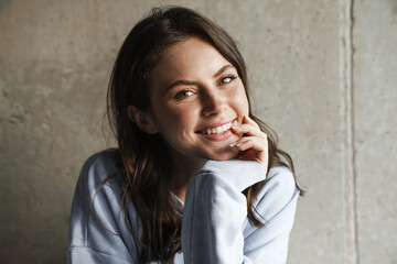 Image of charming joyful woman smiling and looking at camera © Drobot Dean