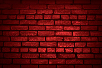Light on an old brick wall. Red grunge background. Old painted wall with cracks. Lighting effect.