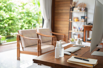 Work from home office gadget hygiene with computer and hand sanitizer protection from coronavirus outbreak or Covid-19
