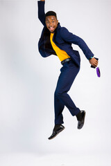 young black handsome man jumping up with joy over something he won