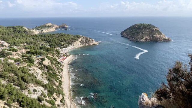 Panoramic view of Cala Barraca beach and Portitxol Island in Javea, Spain