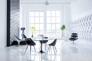 Luxurious futuristic trendy modern interior in contrasting black and white colors with interesting fashionable black furniture and decorated wall