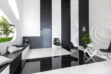 Luxurious futuristic trendy modern interior in contrasting black and white colors with interesting fashionable black furniture and decorated wall