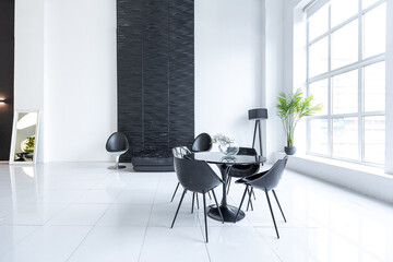 Luxurious futuristic trendy modern interior in contrasting black and white colors with interesting fashionable black furniture and decorated wall