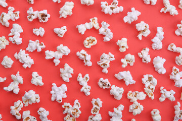 Popcorn on red background top view close up