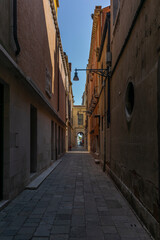 Fototapeta na wymiar The light and shadows in the empty narrow alleys of Venice during the coronavirus