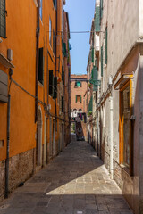 Naklejka na ściany i meble The light and shadows in the empty narrow alleys of Venice during the coronavirus