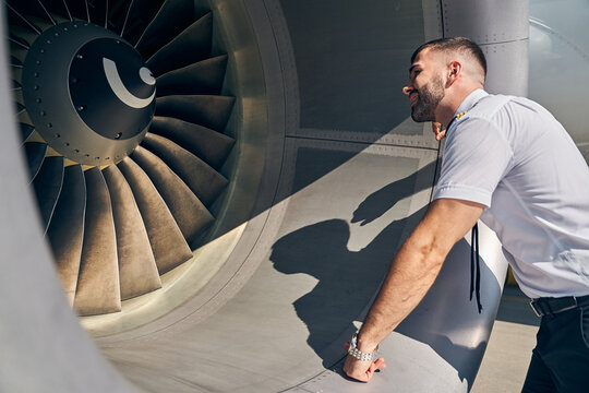 Focused young pilot inspecting an air vehicle