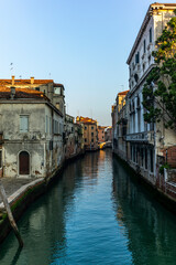 View of the  water channels, bridges and old palaces in Venice at sunrise during the lockdown