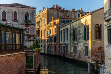 View of the  water channels, bridges and old palaces in Venice at sunrise during the lockdown