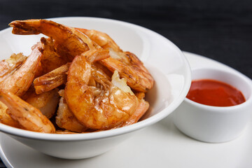 Fried shrimps with tomato sauce on plate