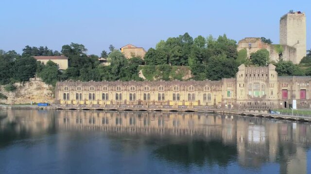 Aerial view of of the Castello Visconteo and Centrale Idroelettrica Taccani (Taccani hydroelectric power plant) on the shores of river Adda, Trezzo sull'Adda, Italy