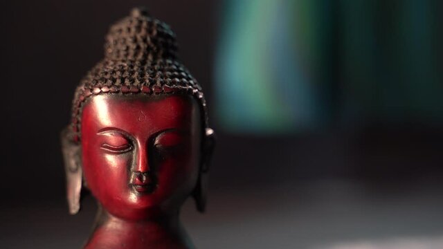 buddha red Idol face mediating with dark background