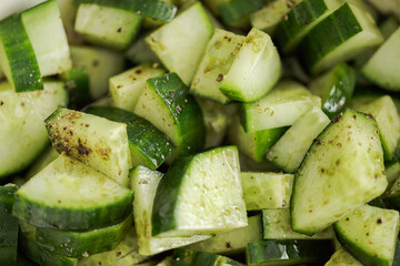 Close up flat lay of slices of homegrown salad cucumber cut into quadrants