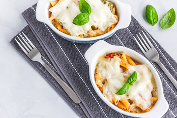 Traditional Italian Baked Pasta with Chicken Garnished with Basil Leaves Directly from Above Horizontal Photo