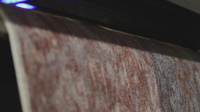 Industrial printer making new wallpaper sample. Modern wallpaper factory. Wallpaper production. One of step creation new wallpaper. Closeup