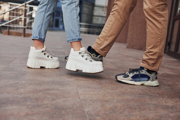 Close up view of woman's and man's legs in greeting position at quarantine time. Conception of coronavirus