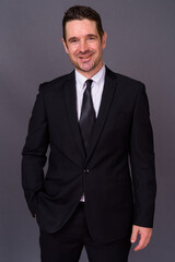 Fototapeta premium Portrait of happy handsome bearded businessman in suit