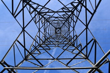 View from inside the medium voltage electrical tower. Blue sky and contrails of planes.