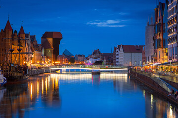 Amazing architecture of Gdansk old town at night with a new footbridge over the Motlawa River. Poland