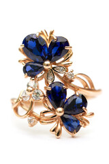 Gold ring with blue sapphires on a white background