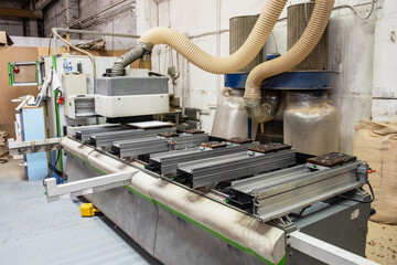 Wooden furniture production. Industrial machine for automatic wood drilling the mounting holes