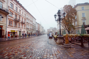 Rainy weather at central Market Square with lamposts and cobbled streets