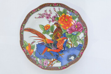 Round porcelain saucer with a beautiful multicolored painting