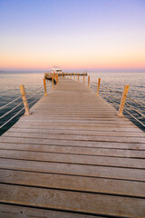 Obraz premium Wooden Pier on Red Sea in Hurghada at sunset and luxury yacht, View of the promenade boardwalk - Egypt, Africa