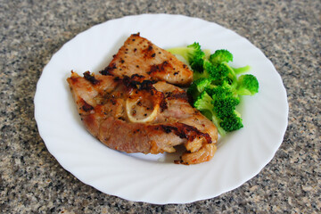 Kurobuta pork steak in black pepper sauce serve with broccoli in dish