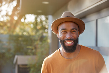 Portrait Of Smiling African American Man Wearing Hat In Garden At Home