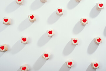 Wooden cubes with red hearts and bright background