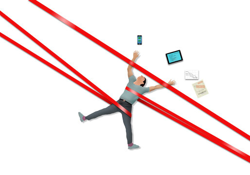 A Man Working On A Project With His Tablet, Phone And Paperwork Is Strapped Down By Red Tape In This Illustration About Bureaucracy Slowing Things Down.