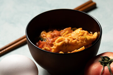 Scrambled eggs with tomatoes is a home cooked meal in Taiwan,China and other east asia area.Scrambled eggs with boiled tomatos,based with tomato sauce and pepper,sugar and salt.