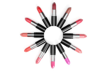 Lipsticks of different colors arranged in a circle on white background. 3d illustration.