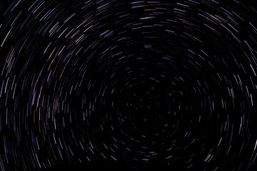 Circular star light trails. Starry background. Night sky rotation. Deep space concept.