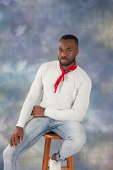 Handsome black man in a red bandanna sitting thoughtfully