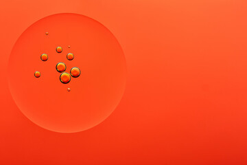 Current collection of brilliant backgrounds for your design. Close-up shot of golden oil bubbles in water circle on orange surface.