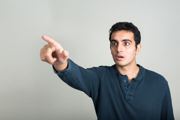Fototapeta premium Portrait of young handsome Indian man against white background