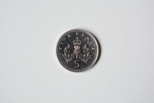 Five pence coin closeup, isolated on white background