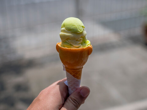 Holding An Avocado Flavored Sorbetes, An Ice Cream Made In The Philippines.