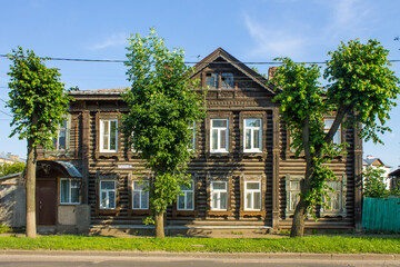 Fototapeta na wymiar old wooden traditional two-story house on a clear summer day in Kostroma Russia and copy space