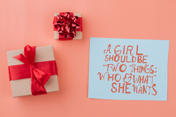 Wrapped vintage gift boxes with red ribbon bow. Isolated on orange background.