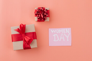Women day and gift boxes top view. Isolated on orange background.