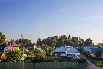 Panoramic view of the city of Kostroma Russia with old wooden houses and temples among green trees...