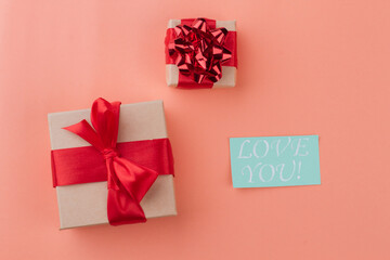 Gift boxes with love you note. Top view flat lay. Isolated on orange background.